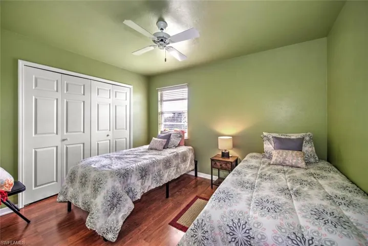Bedroom with wood finished floors, a closet, and a ceiling fan