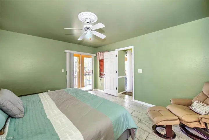 Bedroom featuring ceiling fan and access to exterior