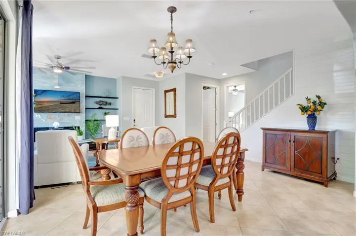 Dining space featuring  chandelier and light tile patterned floors