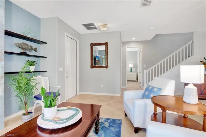 living room leads to spare bedroom/bath and stairway to upper level