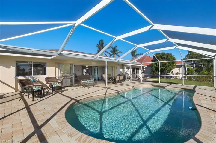 View of swimming pool with a lanai and a patio
