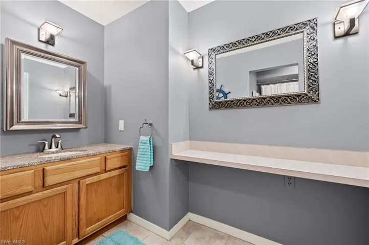 Bathroom featuring tile patterned flooring and vanity