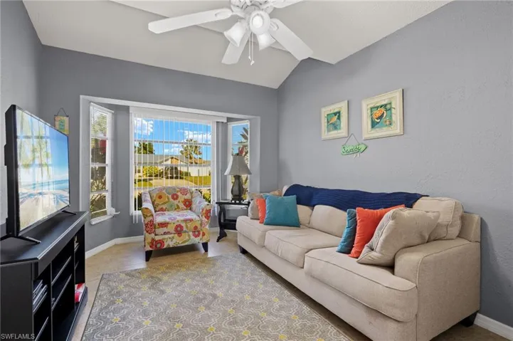Living room with ceiling fan and vaulted ceiling