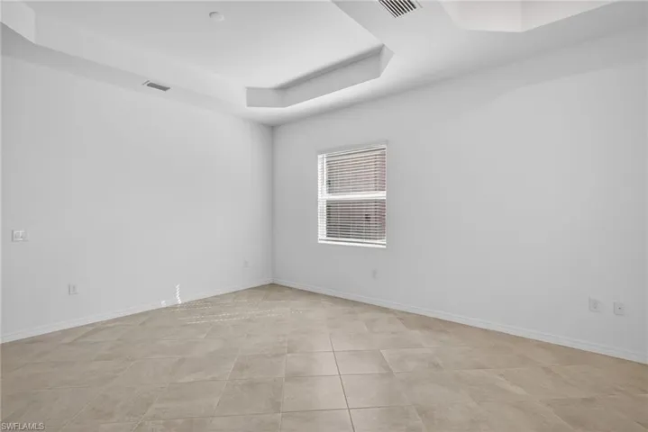Dining room with a raised ceiling and baseboards