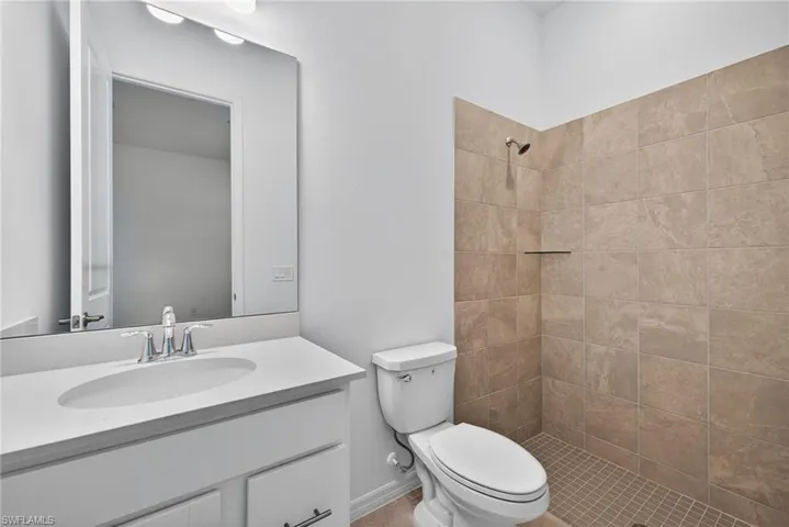Bathroom with vanity and a tile shower