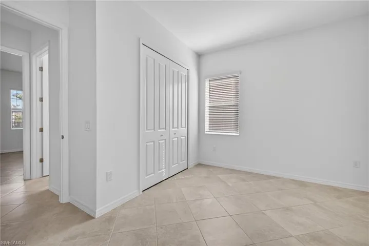 Bedroom featuring a closet and light tile patterned floors