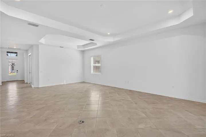 Family/Dining room featuring a raised ceiling, recessed lighting, and plenty of natural light