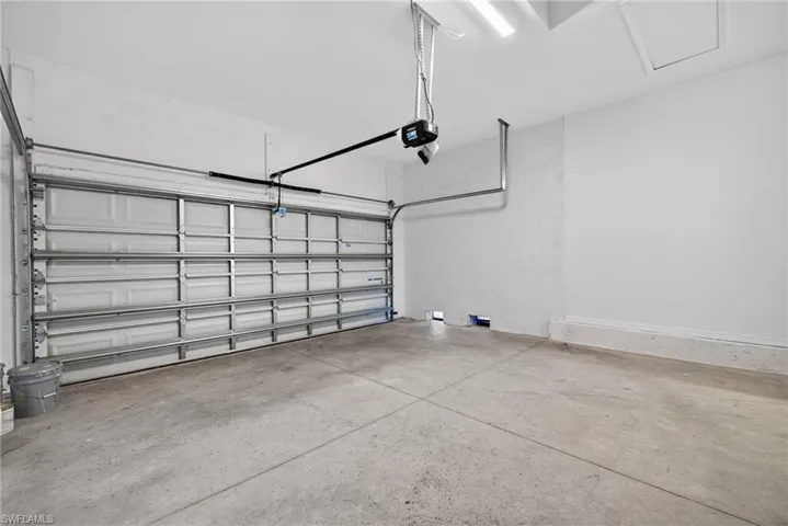 Garage with concrete block wall and a garage door opener