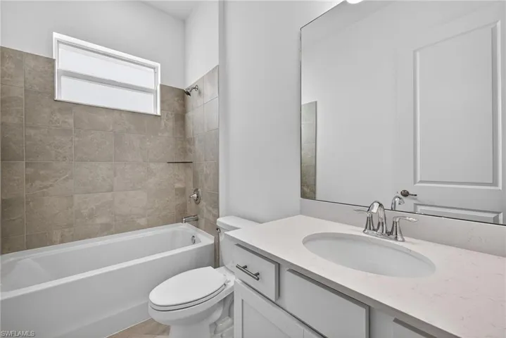 Bathroom with vanity and washtub / shower combination