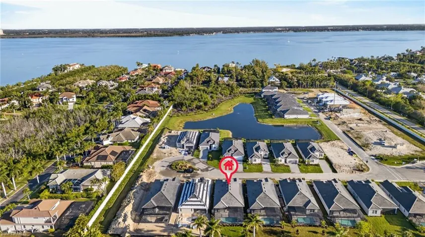 Aerial perspective of suburban area featuring a nearby body of water