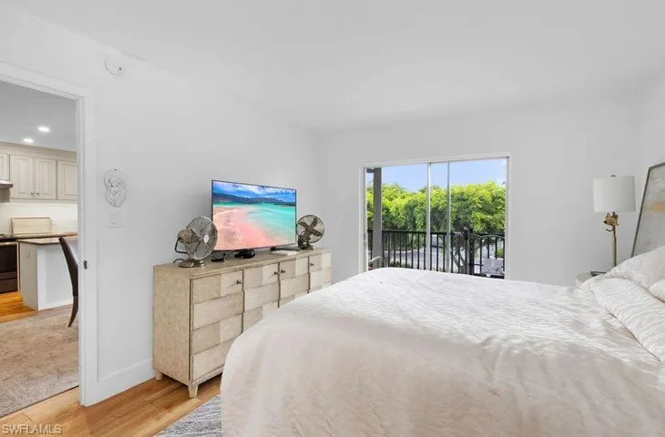 Bedroom with access to outside and light hardwood / wood-style floors