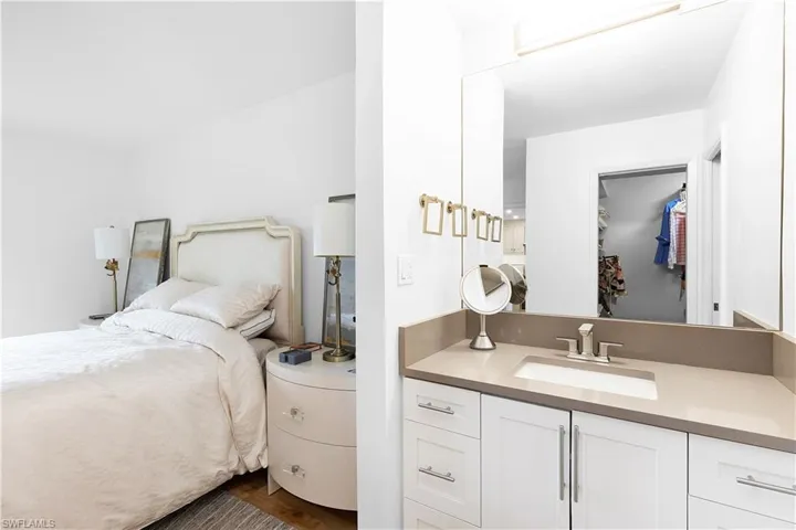 Bedroom with sink and dark hardwood / wood-style floors