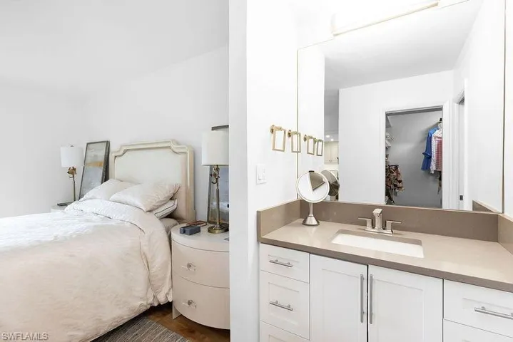 Bedroom featuring dark wood-type flooring, a closet, and sink