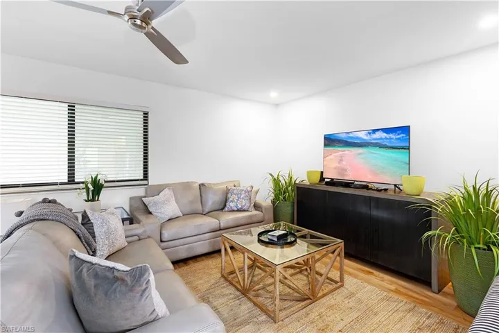 Living room featuring light wood-type flooring and ceiling fan