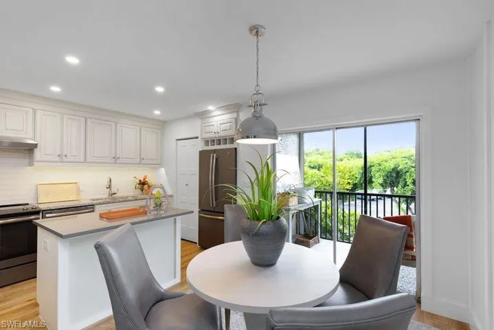 Dining space with sink and light hardwood / wood-style floors