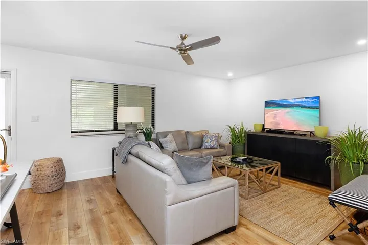 Living room featuring light wood-type flooring and ceiling fan
