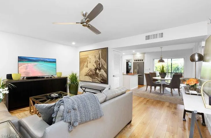 Living room featuring light hardwood / wood-style flooring and ceiling fan