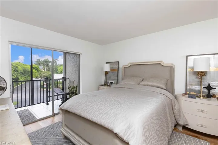 Bedroom with access to outside and wood-type flooring