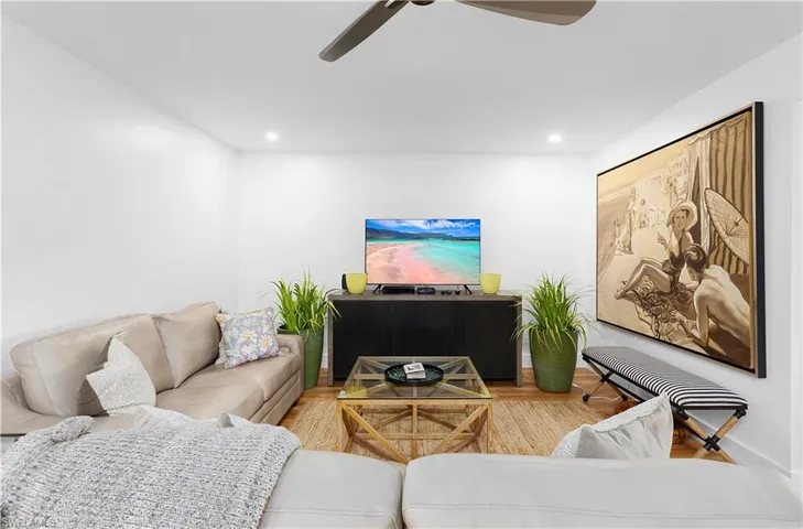 Living room featuring light hardwood / wood-style floors and ceiling fan