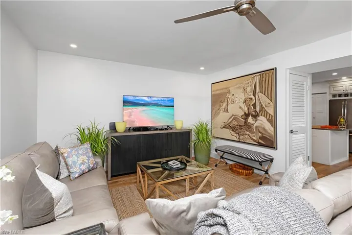 Living room featuring light hardwood / wood-style floors and ceiling fan