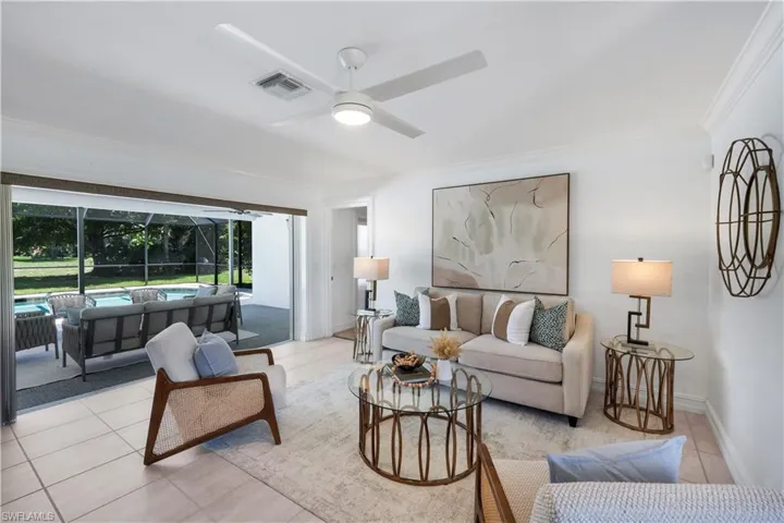 Living room with sliding door access to the lanai and access to the primary bedroom.