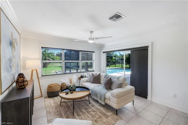 Family room off the kitchen and breakfast nook/wet bar with sliding glass door access to the pool.