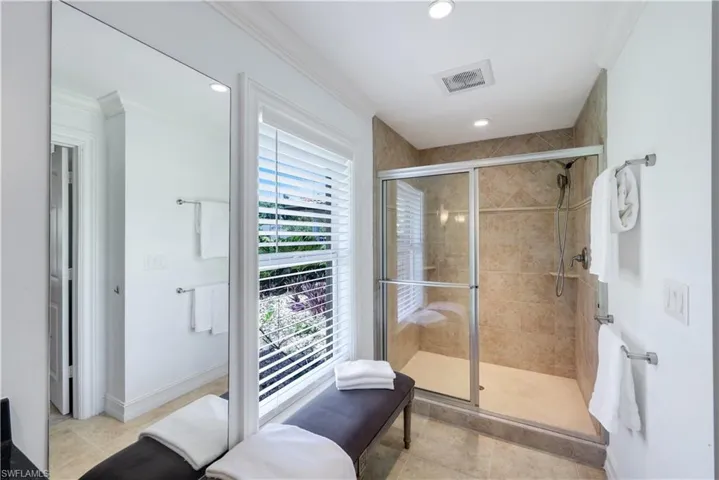 Primary bathroom shower with tile to the ceiling.