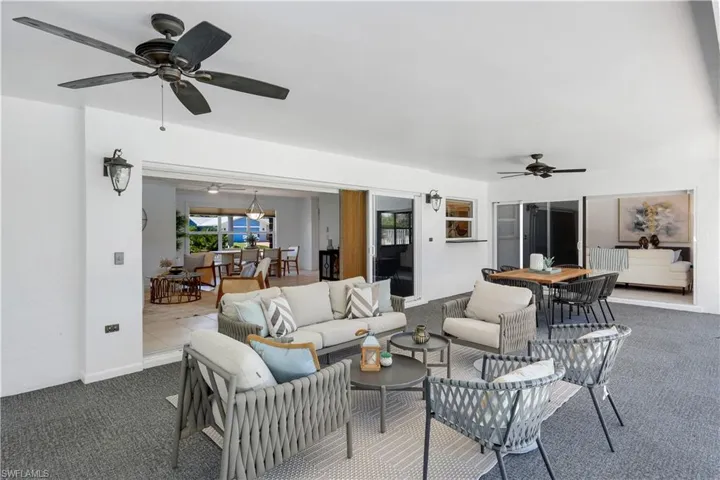 Screened, carpeted lanai with pass through window, lighting, ceiling fans with access to the main living area (family room and living room).