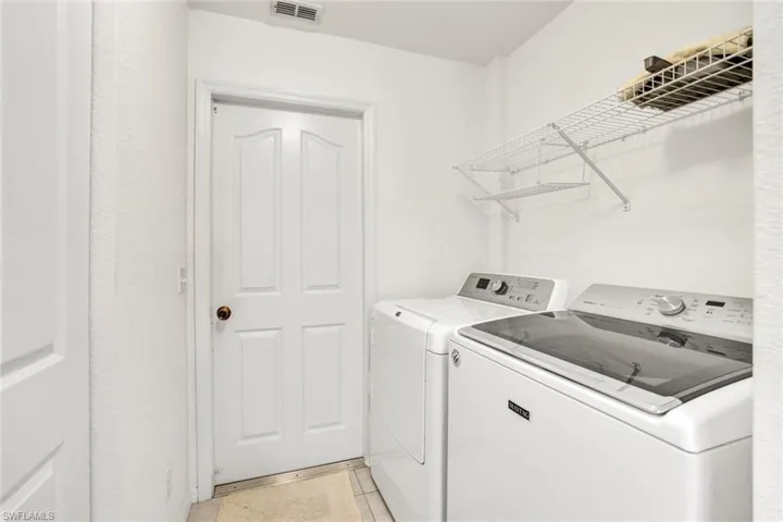 Laundry room with closet and ceramic tile flooring.