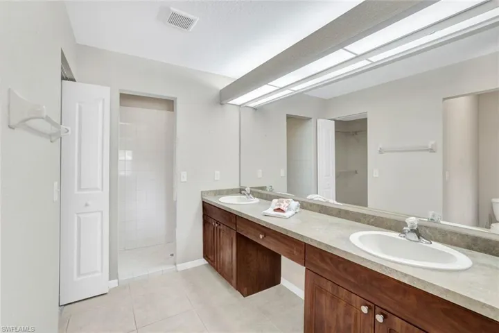 Double-vanity, shower, and large walk-in closet in this master bath.