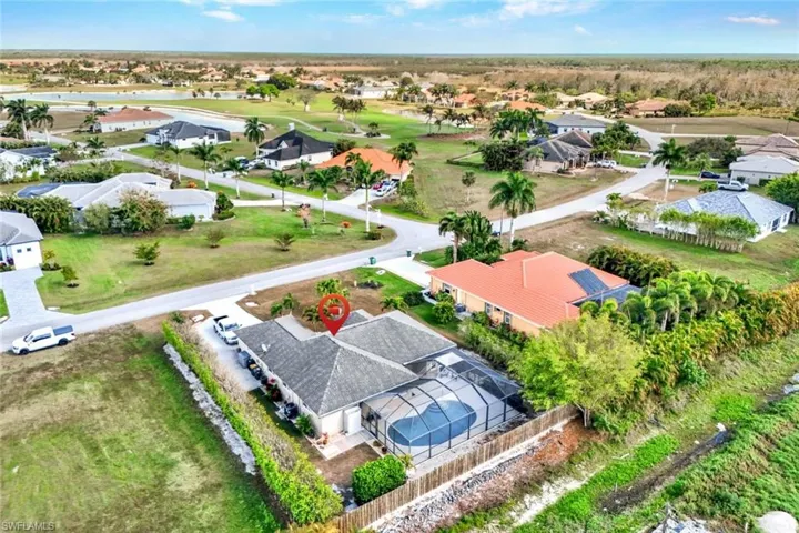 Aerial perspective of suburban area featuring a golf course