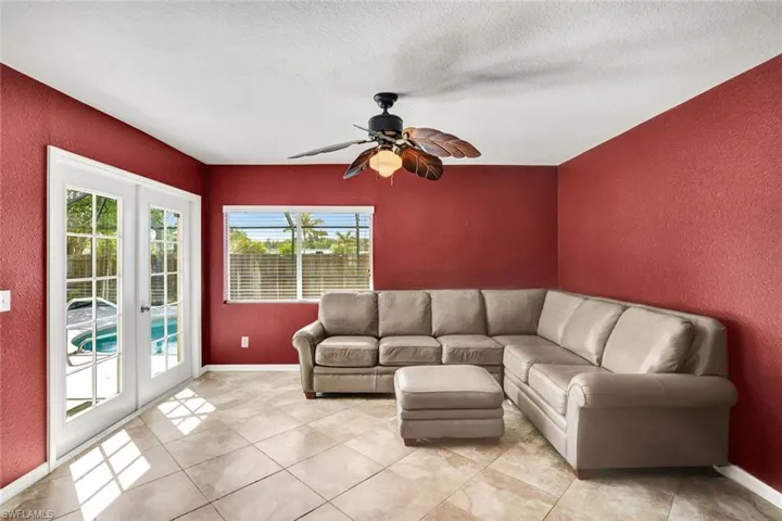 Second living area with ceramic tile floors and French doors to the pool/lanai.