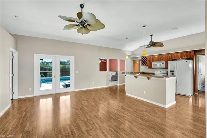 Living room with open layout to kitchen and dining.