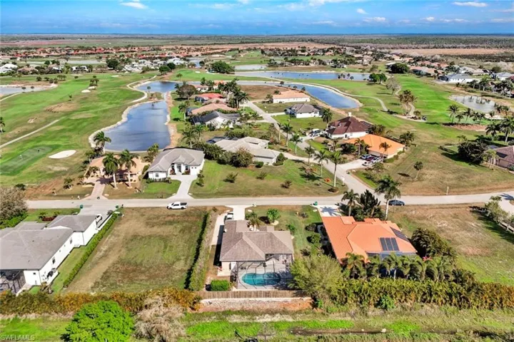 Aerial view of residential area featuring a golf course.