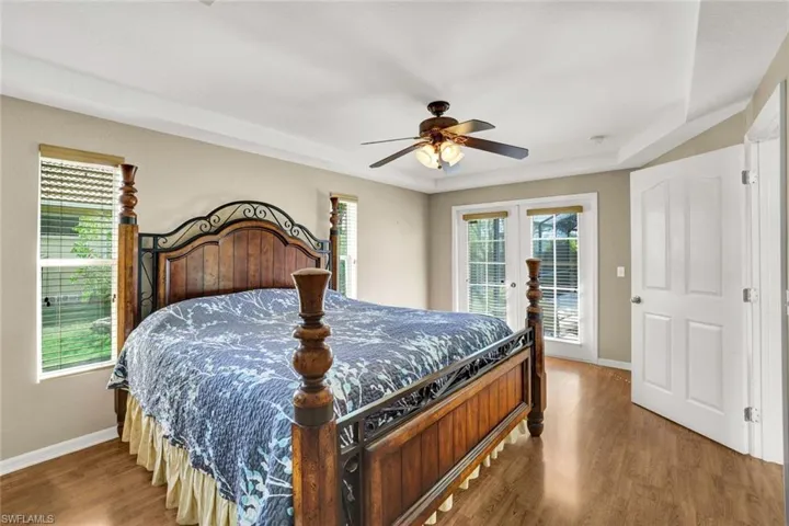 Spacious master with tray ceiling and French doors to pool/lanai.