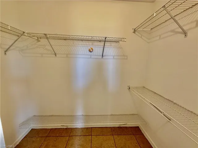 Walk in closet in primary bedroom.