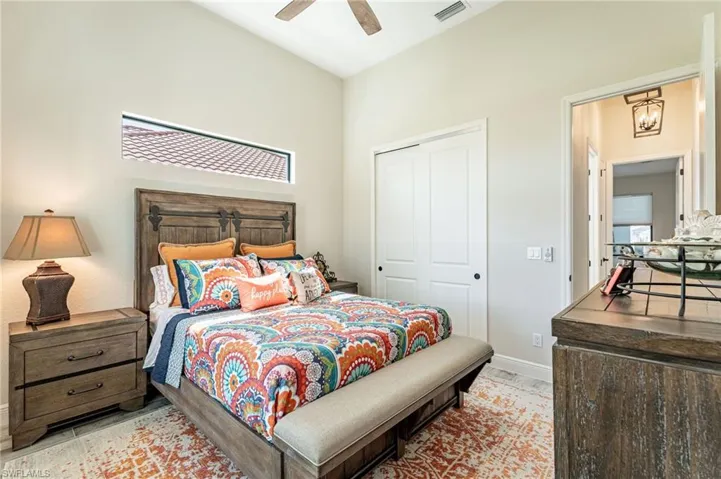 Bedroom with ceiling fan and a closet