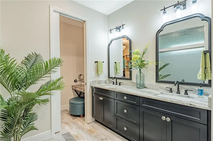 Bathroom featuring oversized vanity, hardwood / wood-style flooring, and double sink