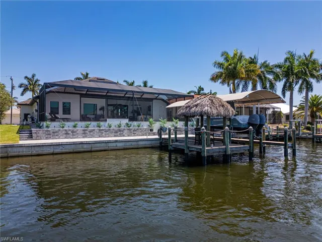 Dock area featuring a 10,000 lb lift and a tiki water view.