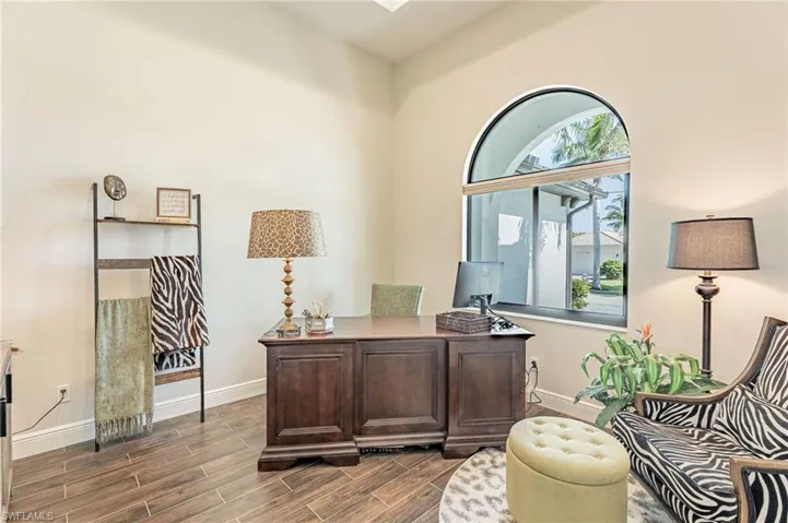 Home office featuring dark wood-type flooring