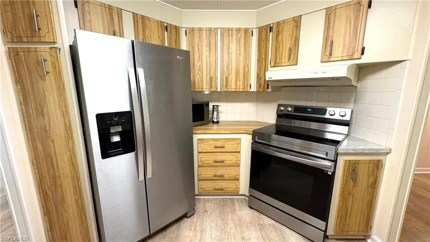 Bright & airy kitchen with NEW stainless steel dishwasher, double-door refrigerator with ice, glass-top stove, microwave, and disposal.