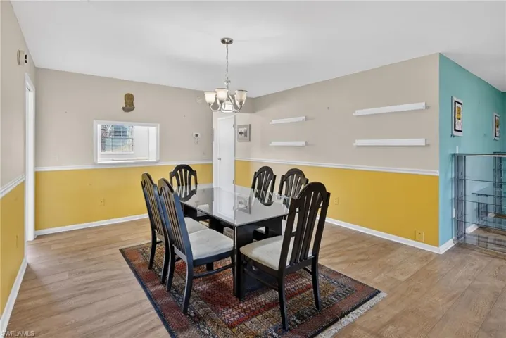 Dining room featuring light wood finished floors and a chandelier