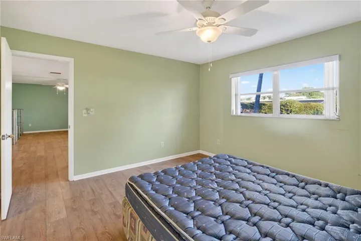 Bedroom featuring wood finished floors and ceiling fan