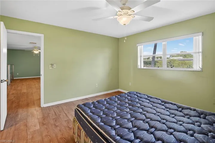 Bedroom featuring wood finished floors and ceiling fan