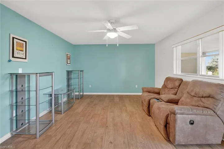Living room featuring light wood finished floors and ceiling fan