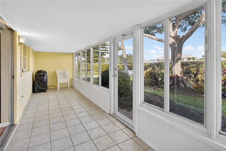 Unfurnished sunroom featuring tile patterned flooring