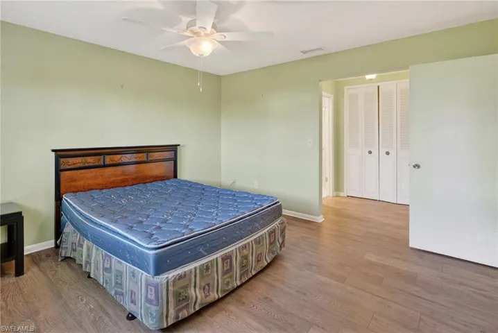 Bedroom with wood finished floors and ceiling fan