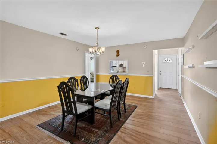 Dining space featuring light wood-style flooring and a chandelier