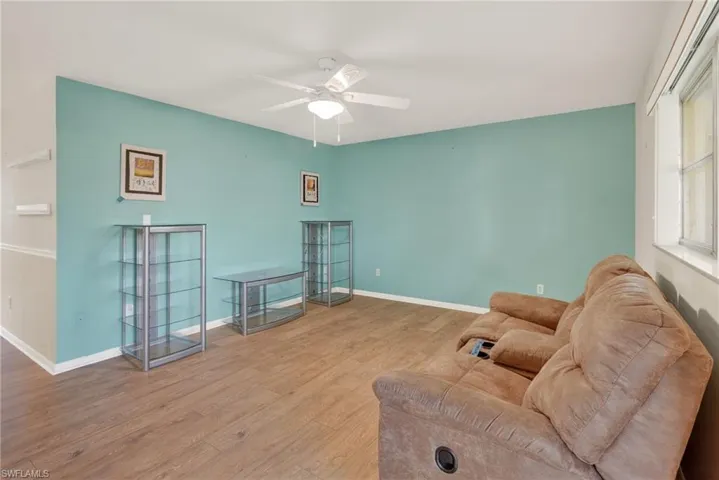 Living area featuring wood finished floors and ceiling fan