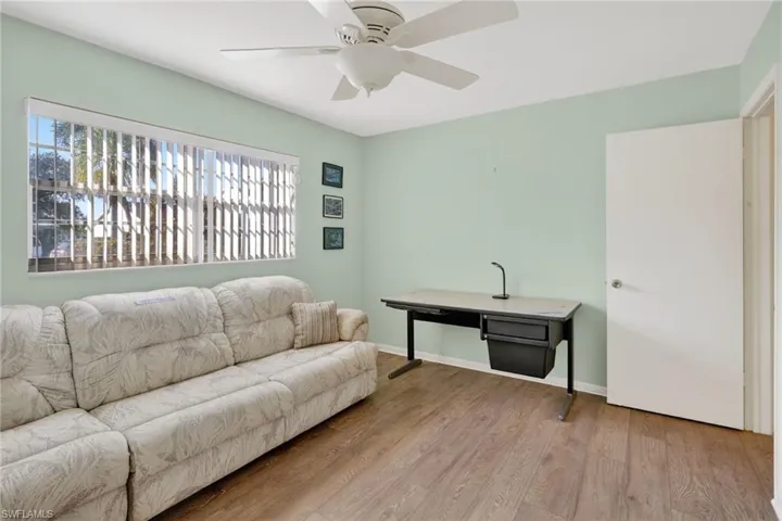 Living area with wood finished floors and ceiling fan